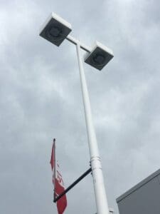 Streetlight pole with overcast sky background.
