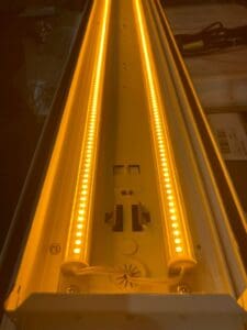 Amber LED light fixture with two tubes.