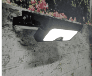 Black outdoor security light mounted on wall.