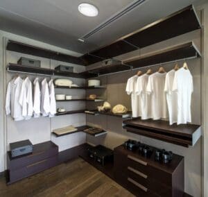 Modern closet with white shirts and shoes.