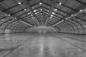 Empty warehouse with concrete floor.