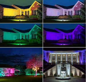 House illuminated with colored spotlights at night.