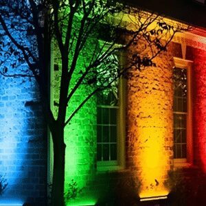 Colorful lights illuminating building at night.