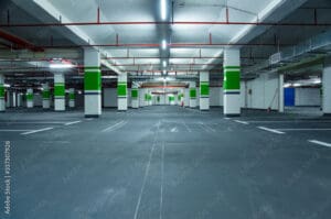 Empty parking garage with green accents.