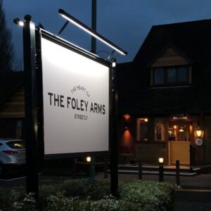 The Foley Arms pub sign at night.