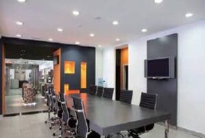 Modern office conference room with black chairs.