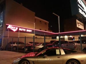 Alex's Auto Body shop at night.