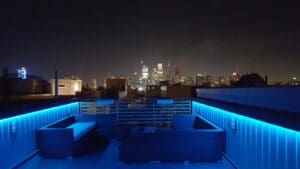 Night rooftop view of city skyline.