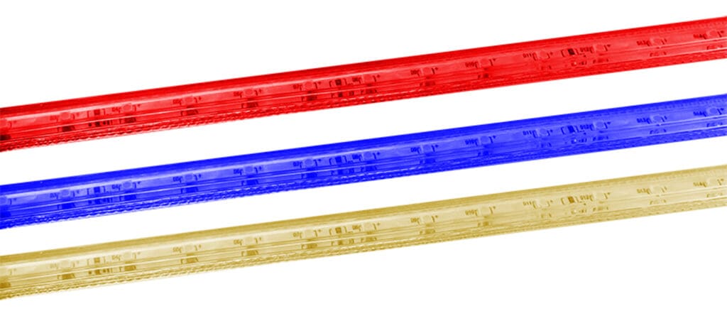 Three plastic rulers in red, blue, and yellow.