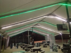 Tented dining area with green lights.