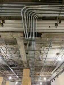 Metal conduit pipes installed in ceiling.