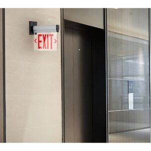 Exit sign next to an elevator door.